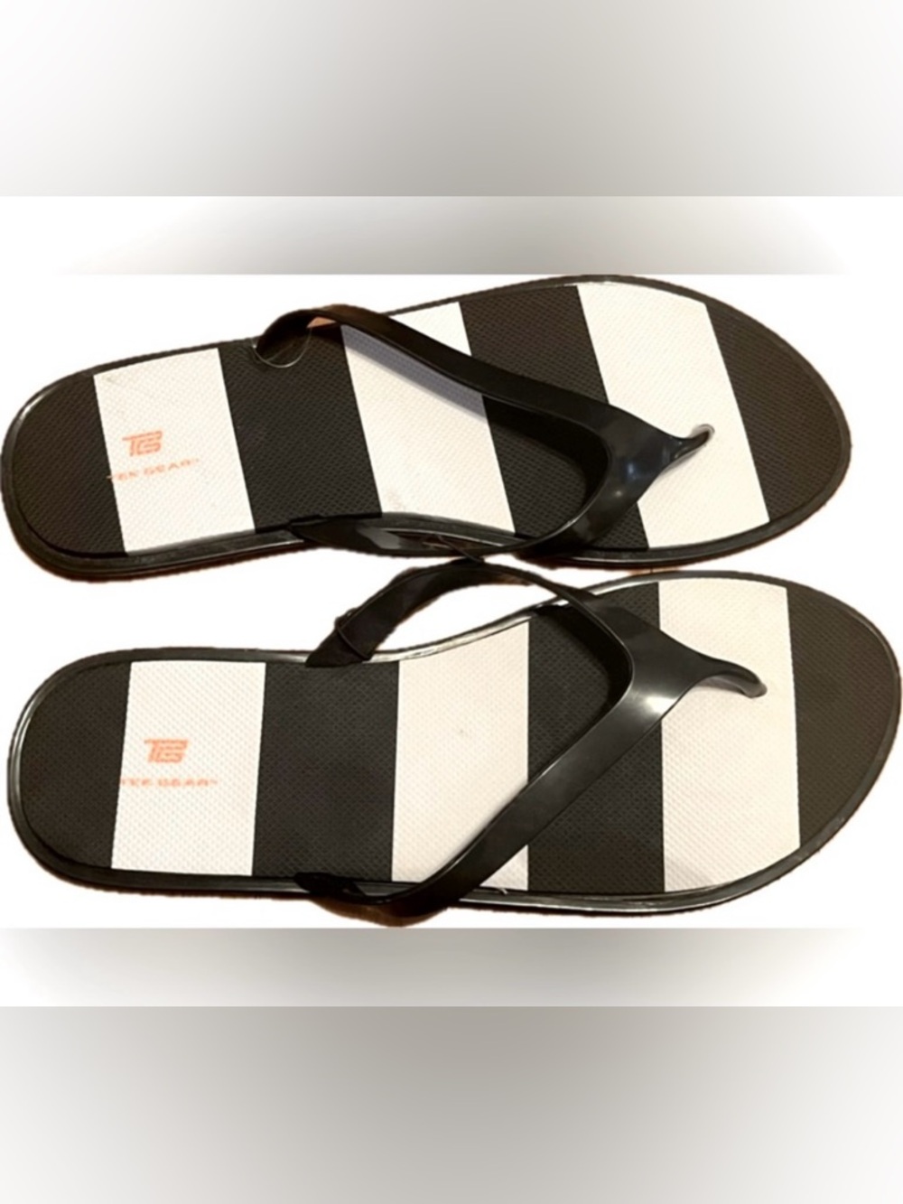 Tek Gear black and white flip flops. New with tag. Women’s size L (9-10)